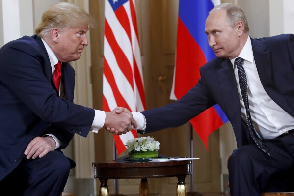 FILE - President Donald Trump, left, and Russian President Vladimir Putin shake hands at the beginning of a meeting at the Presidential Palace in Helsinki, Finland, July 16, 2018. (AP Photo/Pablo Martinez Monsivais, File)