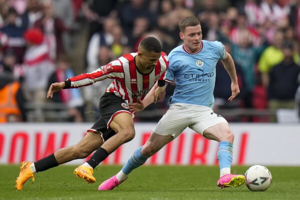 FILE - Manchester City's Sergio Gomez, right, and Sheffield United's Iliman Ndiaye, left, duels for the ball with during the English FA Cup semi final soccer match between Manchester City and Sheffield United at Wembley stadium, in London, on April 22, 2023. Sergio Gomez has left Manchester City to join Real Sociedad on a permanent deal. (AP Photo/Alastair Grant, File)