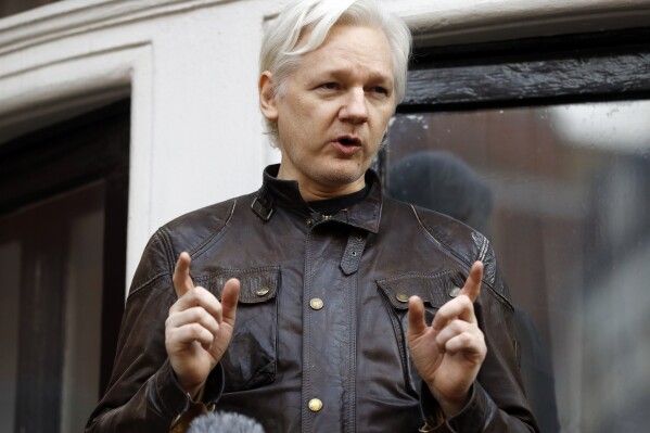 FILE - Julian Assange speaks to the media outside the Ecuadorian embassy in London, May 19, 2017. Assange will plead guilty to a felony charge in a deal with the U.S. Justice Department that will free him from prison and resolve a long-running legal saga over the publication of a trove of classified documents. (AP Photo/Frank Augstein, File)