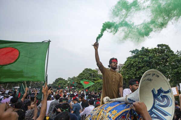 Students and other activists carry Bangladesh's national flag during a protest march organized by Students Against Discrimination to mark one month since former Prime Minister Sheikh Hasina stepped down after a mass uprising, in Dhaka, Bangladesh, Thursday, Sept. 5, 2024. (AP Photo/Rajib Dhar)