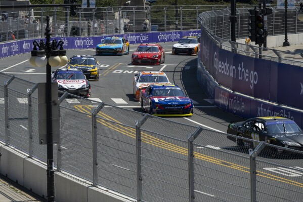 Cars navigate turn 19 during a NASCAR Xfinity Series street course auto race in Grant Park, Saturday, July 6, 202 4 in Chicago. (Tyler Pasciak LaRiviere/Chicago Sun-Times via AP)