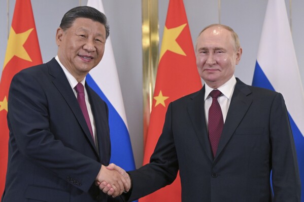 Russian President Vladimir Putin, left, listens to Kazakhstan's President Kassym-Jomart Tokayev during their meeting on the sidelines of the Shanghai Cooperation Organisation (SCO) summit in Astana, Kazakhstan, Wednesday, July 3, 2024. (Sergei Guneyev, Sputnik, Kremlin Pool Photo via AP)