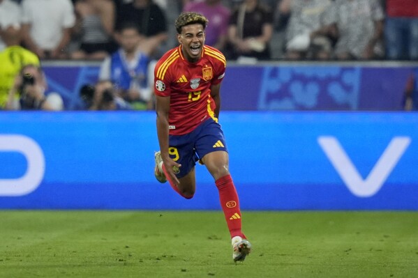 Spain's Lamine Yamal celebrates after scoring his side's first goal during a semifinal match between Spain and France at the Euro 2024 soccer tournament in Munich, Germany, Tuesday, July 9, 2024. (AP Photo/Matthias Schrader)