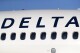 FILE -FILE - A Delta Air Lines jetliner is shown at Denver International Airport in Denver, June 26, 2019. Delta Air Lines is changing its employee uniform policy following a turbulent ride through a social media storm started by a passenger's outrage over two flight attendants photographed wearing Palestinian pins. (AP Photo/David Zalubowski, File)