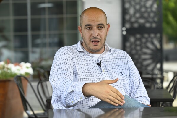 Uncommitted delegate to the Democratic National Convention Abbas Alawieh answers questions during an interview Wednesday, Aug. 14, 2024, in Dearborn, Mich. (AP Photo/Jose Juarez)