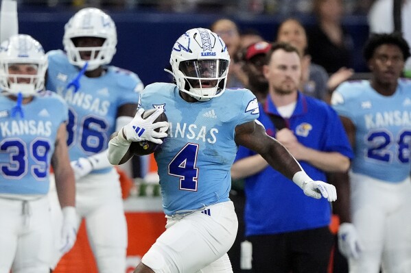 Kansas running back Devin Neal (4) runs for a first down during the first half of an NCAA college football game against Lindenwood Thursday, Aug. 29, 2024, at Children's Mercy Park in Kansas City, Kan. (AP Photo/Charlie Riedel)