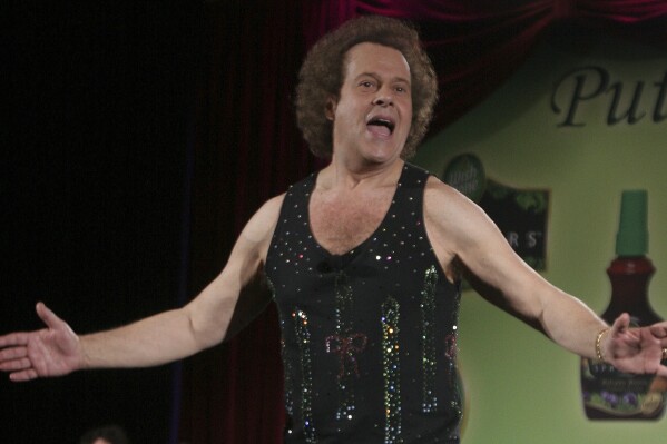FILE - Richard Simmons speaks to the audience before the start of a summer salad fashion show at Grand Central Terminal in New York on June 2, 2006. Simmons, a fitness guru who urged the overweight to exercise and eat better, died Saturday, July 13, 2024, at the age of 76. (AP Photo/Tina Fineberg, File)