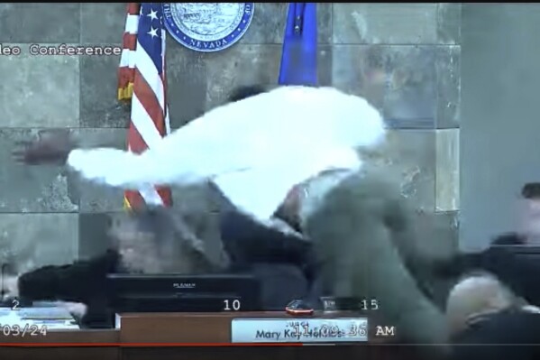 FILE - In this image from video provided by the Clark County District Court, Deobra Redden is seen launching over the desk of Judge Mary Kay Holthus during his sentencing in a felony battery case, Jan. 3, 2024, in Las Vegas. (Clark County District Court via AP, File)