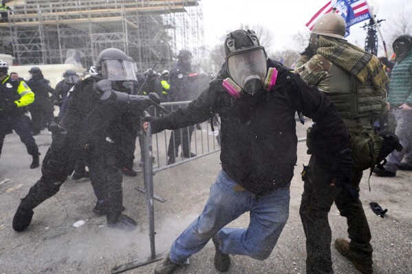 FILE - Insurrectionists loyal to President Donald Trump confront police as they storm the U.S. Capitol on Jan. 6, 2021, in Washington. Former President Donald Trump said during a debate with President Joe Biden last week that the Jan. 6, 2021, attack on the Capitol involved a "relatively small" group of people who were "in many cases ushered in by the police." (AP Photo/Julio Cortez, File)