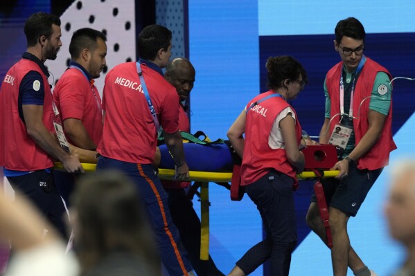 Slovakia’s Tamara Potocka is taken on stretcher from the pool deck after collapsing following a heat of the women's 200-meter individual medley at the 2024 Summer Olympics, Friday, Aug. 2, 2024, in Nanterre, France. (AP Photo/Tsvangirayi Mukwazhi)