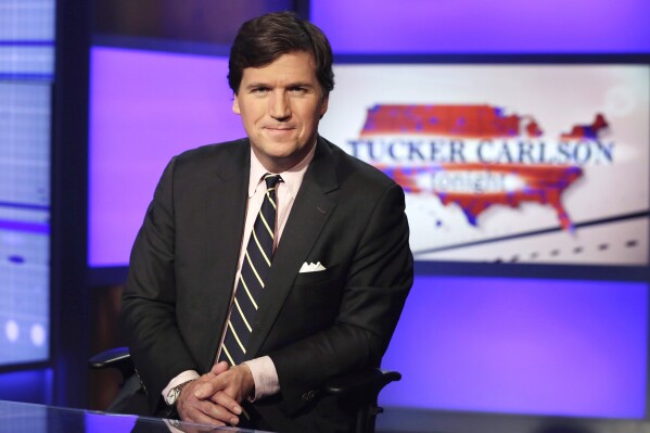 FILE - Tucker Carlson, host of "Tucker Carlson Tonight," poses for photos in a Fox News Channel studio on March 2, 2017, in New York. Fox News sent Carlson a “cease-and-desist” letter over his new Twitter series, Axios reported Monday, June 12, 2023, amid reports of contract battles between the conservative network and its former prime-time host. (AP Photo/Richard Drew, File)