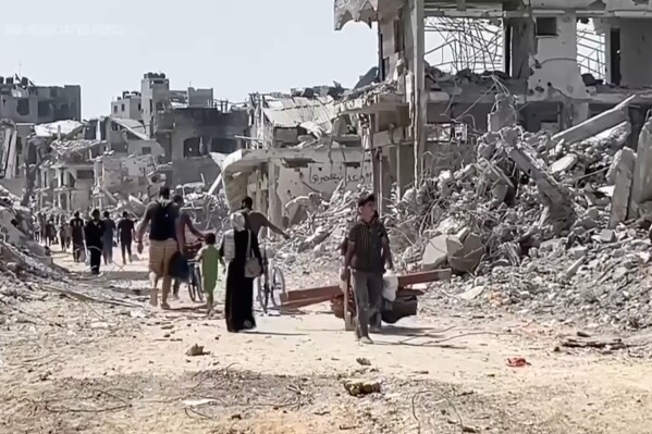 In this image taken from video, Palestinians returned to scenes of destruction in Gaza City's Shijaiyah neighborhood on Thursday, July 11, 2024, after Israeli troops withdrew following a two-week offensive. (AP Photo)