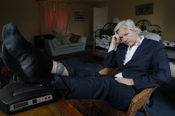 FILE - WikiLeaks founder Julian Assange is seen with his ankle security tag at the house where he is required to stay, near Bungay, England, Wednesday, June 15, 2011. Assange will plead guilty to a felony charge in a deal with the U.S. Justice Department that will free him from prison and resolve a long-running legal saga over the publication of a trove of classified documents. (AP Photo/Kirsty Wigglesworth, File)