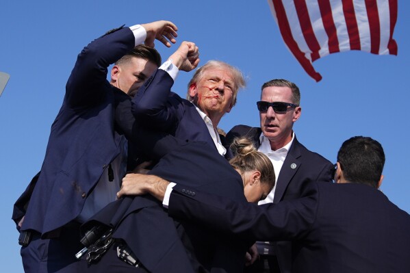 Republican presidential candidate former President Donald Trump is surround by U.S. Secret Service agents at a campaign rally, Saturday, July 13, 2024, in Butler, Pa. (AP Photo/Evan Vucci)