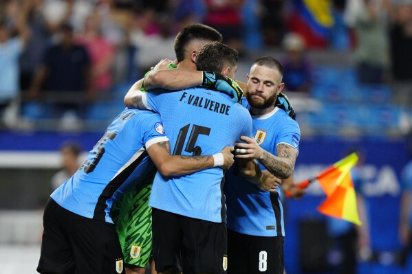 Players of Uruguay celebrate after defeating Canada in a penalty shootout during the Copa America third place soccer match in Charlotte, N.C., Saturday, July 13, 2024. (AP Photo/Jacob Kupferman)