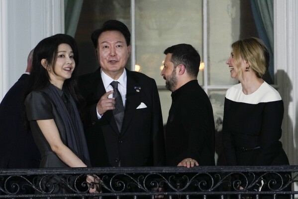 South Korea's President Yoon Suk Yeol accompanied by first lady Kim Keon Hee, left, with Ukraine's President Volodymyr Zelenskyy and his wife Olena Zelenska, far right, on the Blue Room Balcony as President Joe Biden welcome NATO allies and partners to the White House in Washington, Wednesday, July 10, 2024, on the South Lawn for the 75th anniversary of the NATO Summit. (AP Photo/Susan Walsh)