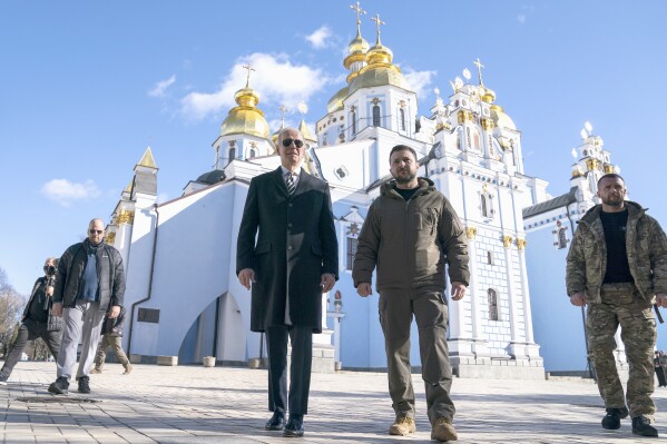 FILE - President Joe Biden walks with Ukrainian President Volodymyr Zelenskyy at St. Michael's Golden-Domed Cathedral on a surprise visit, Feb. 20, 2023, in Kyiv. Historians and political advisers say history will be kinder to President Joe Biden than voters have been. Biden dropped out of the presidential race Sunday, July 21, 2024, clearing the way for a new Democratic nominee. (AP Photo/ Evan Vucci, File)