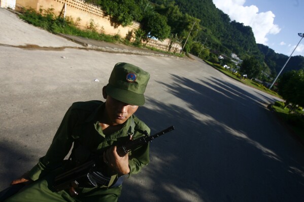 FILE - A soldier from the United Wa State Army is seen on a street of Nandeng in the Wa region of Myanmar, Sept. 3, 2009. Recently renewed combat in northeastern Myanmar between troops of the military government and ethnic minority militias has in the past few days become more complicated, as two minority groups not previously involved in the fighting stepped into the fray, claiming to act as a third force for stability. (AP Photo, File)