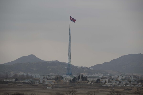 FILE - A North Korean flag flutters in North Korea's village Gijungdong as seen from a South Korea's observation post inside the demilitarized zone in Paju, South Korea during a media tour, March 3, 2023. North Korea threatened Saturday, July 13, 2024, to boost its nuclear fighting capability and get the U.S. and South Korea to face “an unimaginably harsh price” as it slammed its rivals’ new defense guidelines that it says revealed an intention to invade the North. (Jeon Heon-Kyun/Pool Photo via AP, File)
