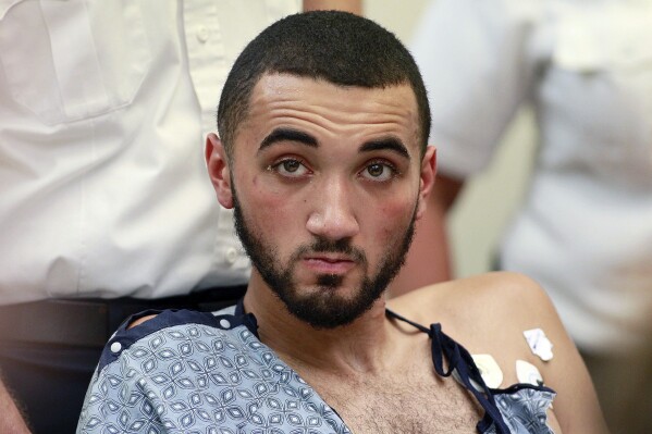 FILE - Emanuel Lopes is seated during his arraignment on murder charges, Tuesday, July 17, 2018, in district court in Quincy, Mass. Lopes was sentenced Wednesday, July 31, 2024, to two consecutive life terms for killing a police officer and a bystander six years ago. (Greg Derr/The Quincy Patriot Ledger via AP, Pool, File)