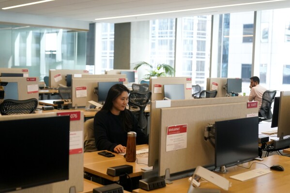 FILE - People work at the Yelp office in San Francisco on Feb. 14, 2023. Remote work has intensified loneliness in the workplace. Experts say friendships and a sense of belonging are vital to employees’ happiness. And also to companies’ success. (AP Photo/Jeff Chiu, File)