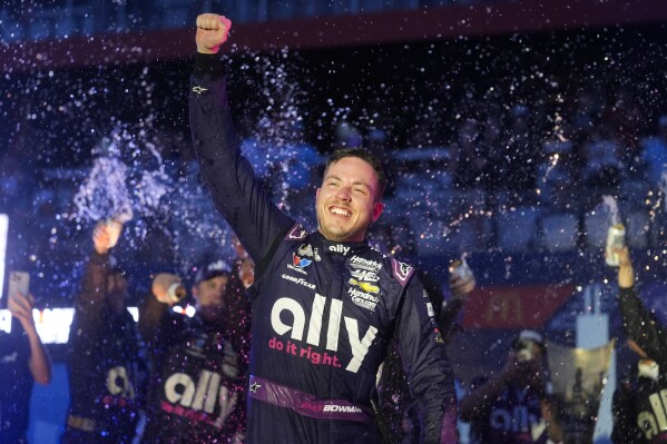 Alex Bowman is sprayed by teammates after winning a NASCAR Cup Series auto race, Sunday, July 7, 2024, in Chicago. (AP Photo/Erin Hooley)