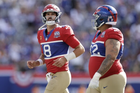 New York Giants quarterback Daniel Jones (8) jogs off the field after throwing an interception during the second half of an NFL football game against the Minnesota Vikings, Sunday, Sept. 8, 2024, in East Rutherford, N.J. (AP Photo/Adam Hunger)