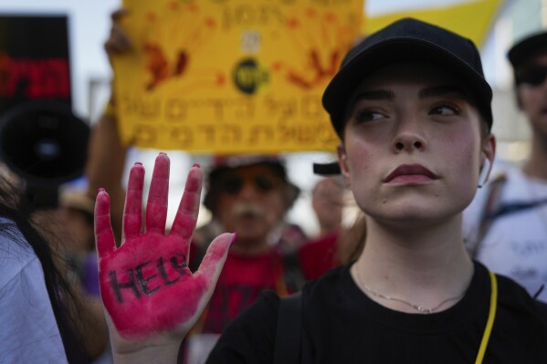 Families and friends of hostages held by Hamas in Gaza call for their return as they begin a four-day march from Tel Aviv to the Prime Minister's house in Jerusalem, in Tel Aviv, Israel, Wednesday, July 10, 2024. (AP Photo/Ohad Zwigenberg)