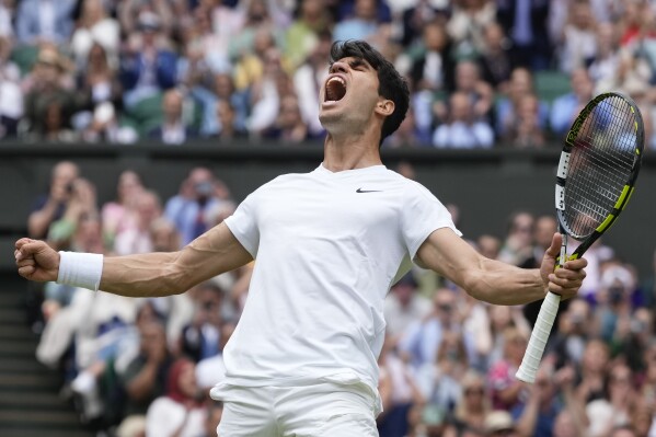 Carlos Alcaraz of Spain celebrates after defeating Daniil Medvedev of Russia in their semifinal match at the Wimbledon tennis championships in London, Friday, July 12, 2024. (AP Photo/Kirsty Wigglesworth)