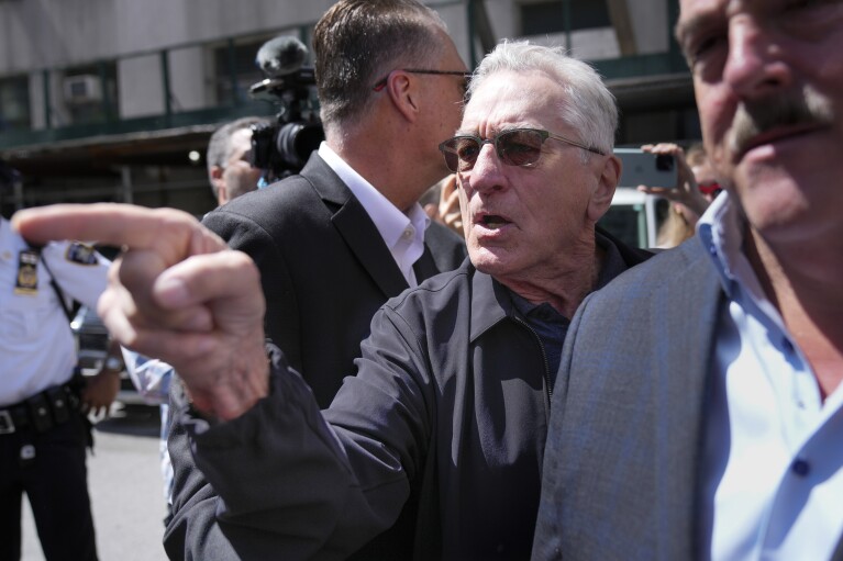 Robert De Niro, center, argues with a Donald Trump supporter after speaking to reporters in support of President Joe Biden across the street from Trump's criminal trial in New York, Tuesday, May 28, 2024. (AP Photo/Seth Wenig)