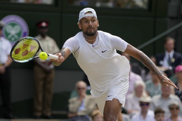 FILE - Australia's Nick Kyrgios returns to Serbia's Novak Djokovic in the final of the men's singles on the 14th day of the Wimbledon tennis championships in London, July 10, 2022. Kyrgios has played just one official singles match since October 2022 because of injuries, but Djokovic said Friday. July 12, 2024, that Kyrgios told him a return might happen at the U.S. Open. (AP Photo/Alastair Grant, File)