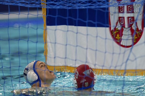 Serbia's Petar Jaksic celebrates winning the men's water polo gold medal match against Croatia, at the 2024 Summer Olympics, Sunday, Aug. 11, 2024, in Paris, France. (AP Photo/Luca Bruno)