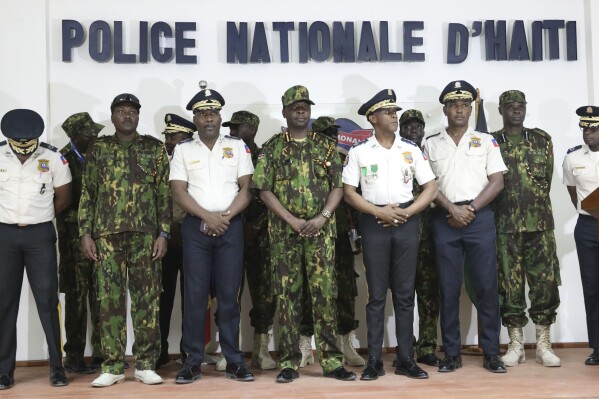Haitian police and members of a UN-backed Kenyan police force pose for photo after a press conference at the police headquarters in Port-au-Prince, Haiti, Monday, July 8, 2024. (AP Photo/Odelyn Joseph)
