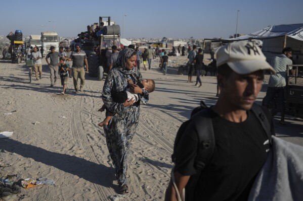 Palestinians flee the Khan Younis area of the Gaza Strip, following Israeli military evacuation orders, saying its forces will soon operate there, Thursday, Aug. 8, 2024. (AP Photo/Abdel Kareem Hana)