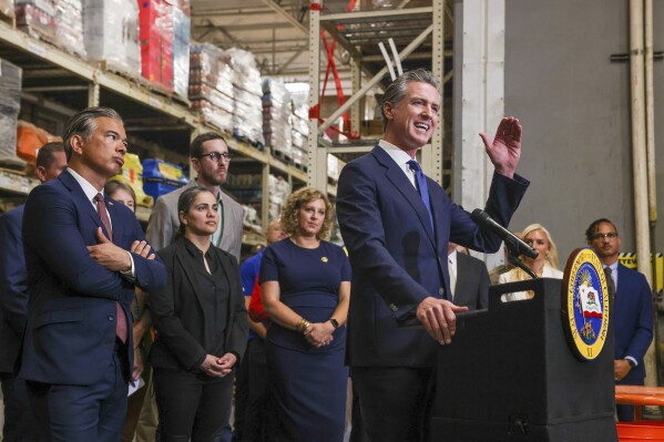 California Governor Gavin Newsom speaks as Attorney General Bob Bonta, second from left, looks on after signing a bipartisan package of bills to combat retail crime during a press conference with state and local officials at Home Depot in San Jose, Calif., on Friday, Aug. 16, 2024. (Ray Chavez/Bay Area News Group via AP)