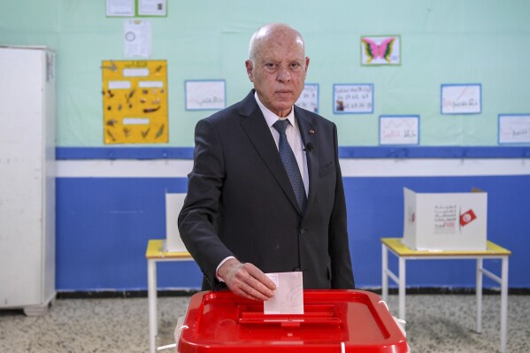 FILE - Tunisia's President Kais Saied casts his ballot as he participates in the legislative elections in Tunis, Dec. 17, 2022. As elections approach in Tunisia, potential presidential candidates are facing arrests as authorities clamp down on those planning to participate. Since President Kais Saied took power in 2019, critics and opponents have been arrested, detained and convicted of political charges stemming from criticism of the government.(AP Photo/Slim Abid, File)