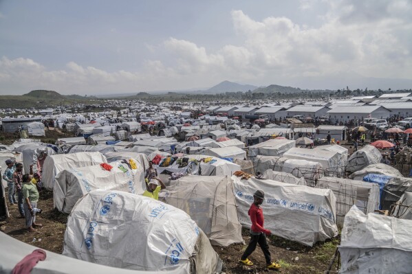 FILE - People displaced by the ongoing fighting between Congolese forces and M23 rebels gather in a camp on the outskirts of Goma, Democratic Republic of Congo, March 13, 2024. Between 3,000 and 4,000 Rwanda government forces are deployed in neighboring eastern Congo, operating alongside the M23 rebel group which has been making major advances, U.N. experts said in a report circulated Wednesday, July 10. (AP Photo/Moses Sawasawa, File)