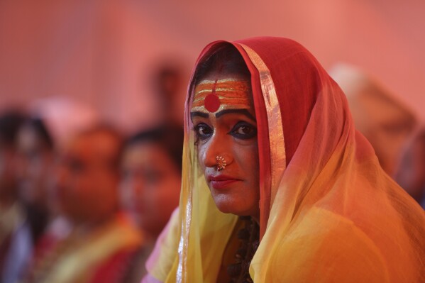 FILE - Laxmi Narayan Tripathi, leader of the "Kinnar Akhara," a monastic order of the transgender community, meets with followers at the Kumbh Mela festival in Pragraj, India, Feb. 5, 2019. The Kumbh Mela is a series of ritual baths by Hindu holy men, and other pilgrims that dates back to at least medieval times. The Vatican has issued a new document rejecting the concept of changing one’s biological sex – a setback for transgender people who had hoped Pope Francis might be setting the stage for a more welcoming approach from the Catholic Church. Around the world, major religions have diverse approaches to gender identity, and the inclusion or exclusion of transgender people. (AP Photo/Channi Anand, File)