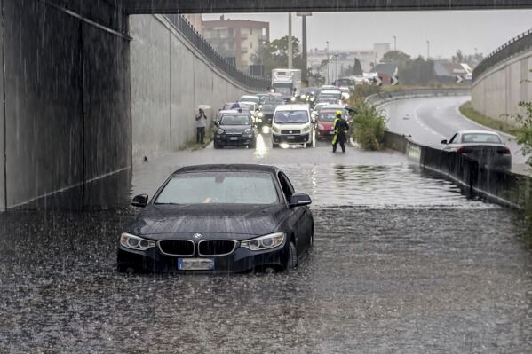 Cars are blocked in flooded streets in Milan, northern Italy, Thursday, Sept. 5, 2024. Lombardy and Veneto have been hit by widespread flooding, causing damage and disruption in the city of Milan, where the local Seveso and Lambro rivers overflowed. (Claudio Furlan/LaPresse via AP)