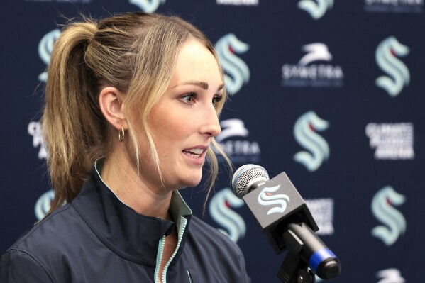 Seattle Kraken new assistant coach Jessica Campbell speaks during an NHL hockey press conference Wednesday, July 3, 2024, in Seattle. Campbell will become the first woman to work on the bench of an NHL franchise after the team hired her as an assistant coach .(AP Photo/Jason Redmond)