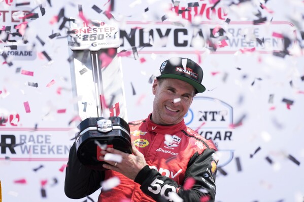 Will Power celebrates after winning an IndyCar auto race, Sunday, July 14, 2024, at Iowa Speedway in Newton, Iowa. (AP Photo/Charlie Neibergall)