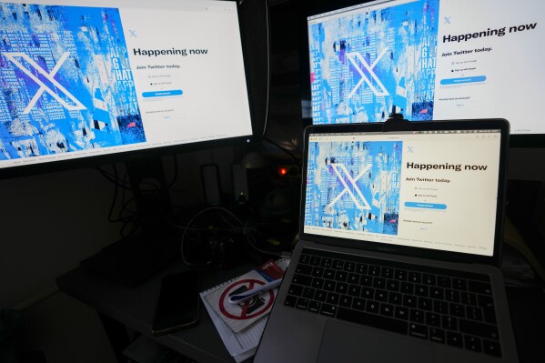 FILE - Computer monitors and a laptop display the X, formerly known as Twitter, sign-in page, July 24, 2023, in Belgrade, Serbia. (AP Photo/Darko Vojinovic, File)