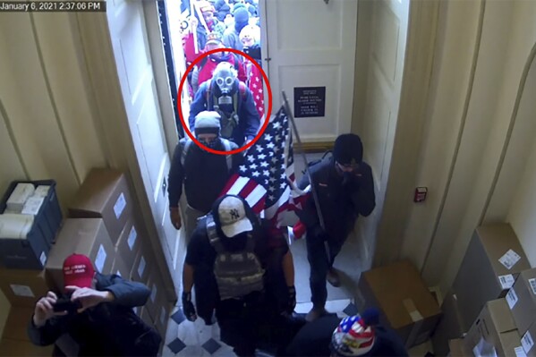 This image from video from the Justice Department in the statement of facts supporting an arrest warrant, and annotated by the source, shows Dan Edwin Wilson, circled in red, entering the U.S. Capitol on Jan. 6, 2021, in Washington. (Department of Justice via AP)