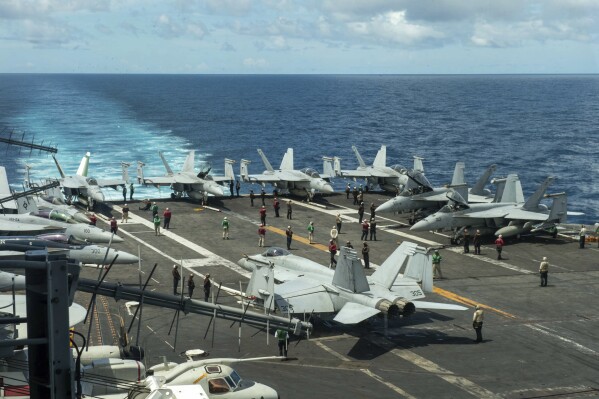 In this photograph released by the U.S. Navy, the flight deck of the Nimitz-class aircraft carrier USS Theodore Roosevelt is seen July 4, 2024, in the South China Sea. The Roosevelt is replacing the USS Dwight D. Eisenhower in the Navy's campaign against attacks by Yemen's Houthi rebels targeting shipping in the Red Sea corridor over the Israel-Hamas war in the Gaza Strip. (Seaman Ryan Holloway/U.S. Navy, via AP)