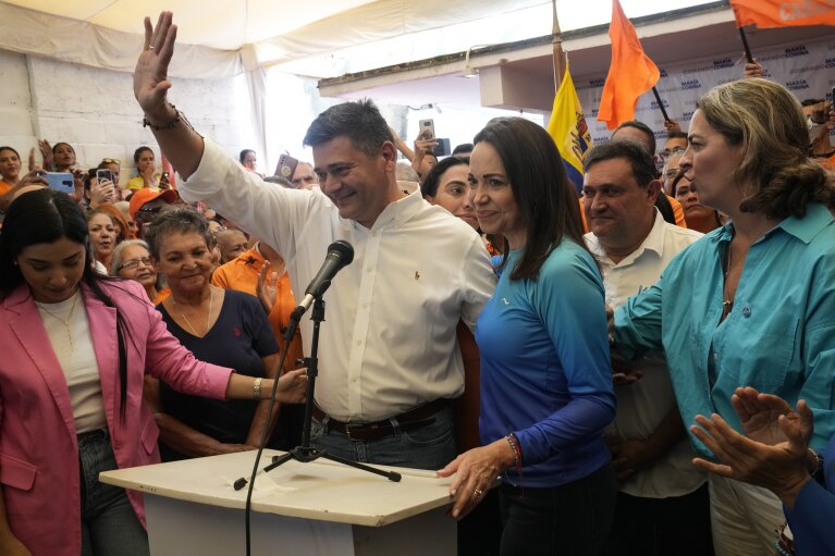 FILE - Venezuelan opposition leader Freddy Superlano holds a press conference to withdraw from the opposition primaries and endorsement of fellow candidate María Corina Machado, center right, in Caracas, Venezuela, Oct. 13, 2023. (AP Photo/Ariana Cubillos, File)