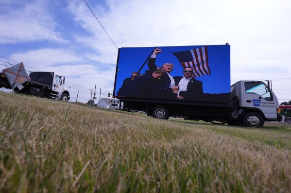 An electronic billboard displays images of former President Donald Trump from his recent rally at the Butler Farm Show, Thursday, July 18, 2024, in Butler, Pa. (AP Photo/Eric Gay)