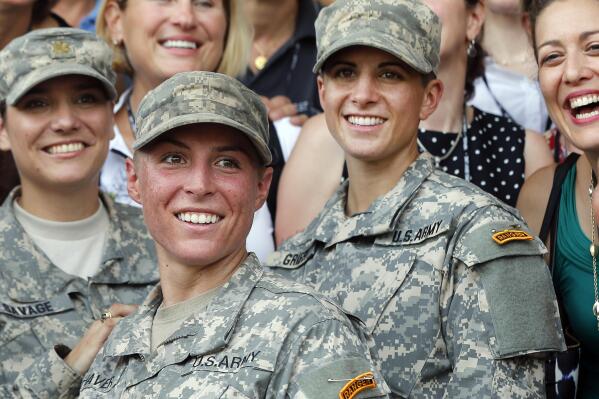 FILE - In this Aug. 21, 2015, file photo, Army 1st Lt. Shaye Haver, center, and Capt. Kristen Griest, right, pose for photos with other female West Point alumni after an Army Ranger school graduation ceremony at Fort Benning, Ga. Haver and Griest became the first female graduates of the Army's rigorous Ranger School. (AP Photo/John Bazemore, File)