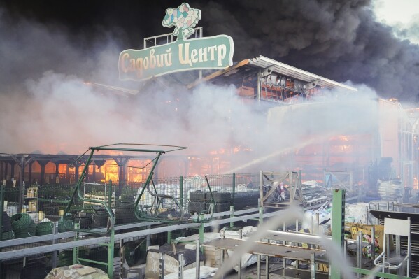 FILE - Firefighters put out a fire after two guided bombs hit the Epicenter shopping complex in Kharkiv, Ukraine, Saturday, May 25, 2024. The sign reads "Garden Center". (AP Photo/Andrii Marienko,File)