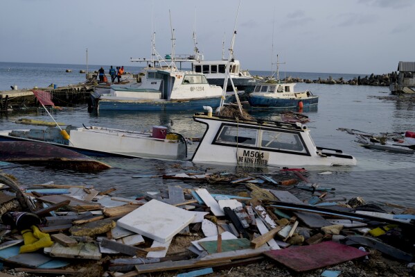 Boats damaged by Hurricane Beryl wade in the water at the Bridgetown Fisheries, Barbados, July 2, 2024. (AP Photo/Ricardo Mazalan)