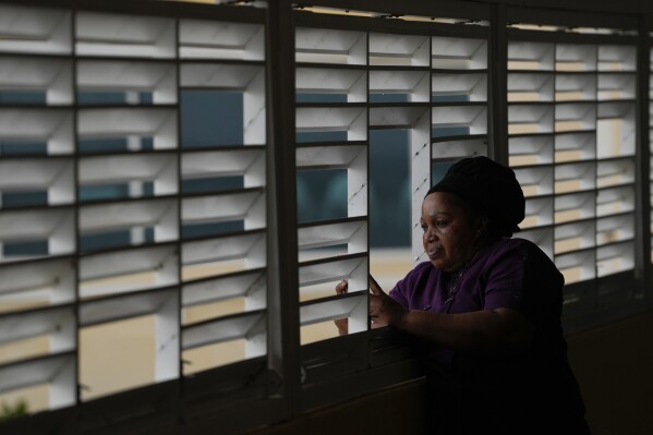 Donna Charles, a hotel cook, watches as Hurricane Beryl passes through Bridgetown, Barbados, July 1, 2024. (AP Photo/Ricardo Mazalan)